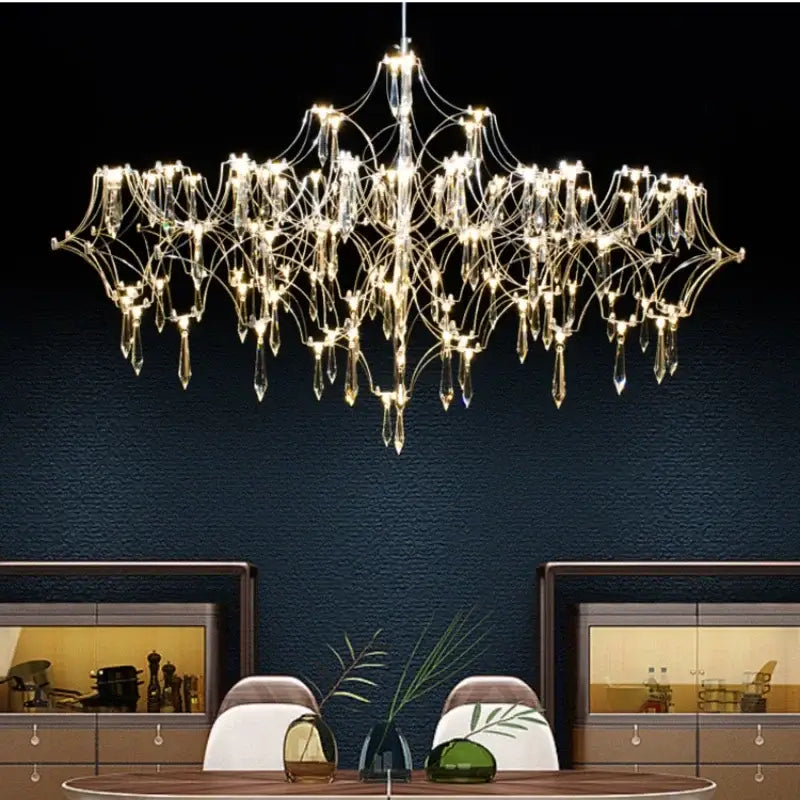 A modern decorbites crystal chandelier with metallic frame and teardrop glass pendants for luxury living spaces
