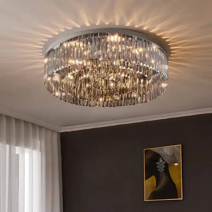 Circular decorbites crystal chandelier ceiling light with multiple tiers of faceted glass rods and warm-toned lighting