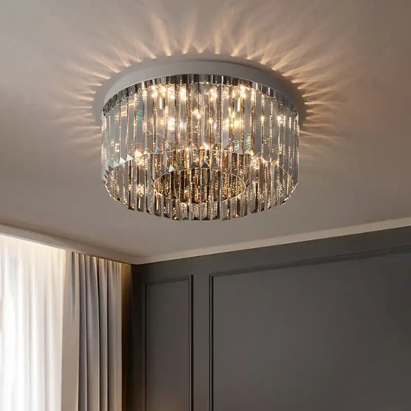 A modern decorbites crystal chandelier with cascading clear crystal prisms and a sleek metallic frame for interior decor