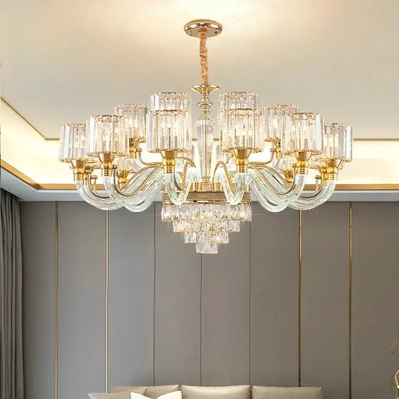 A luxurious gold-toned decorbites crystal chandelier with clear glass shades and cascading crystal droplets for home use