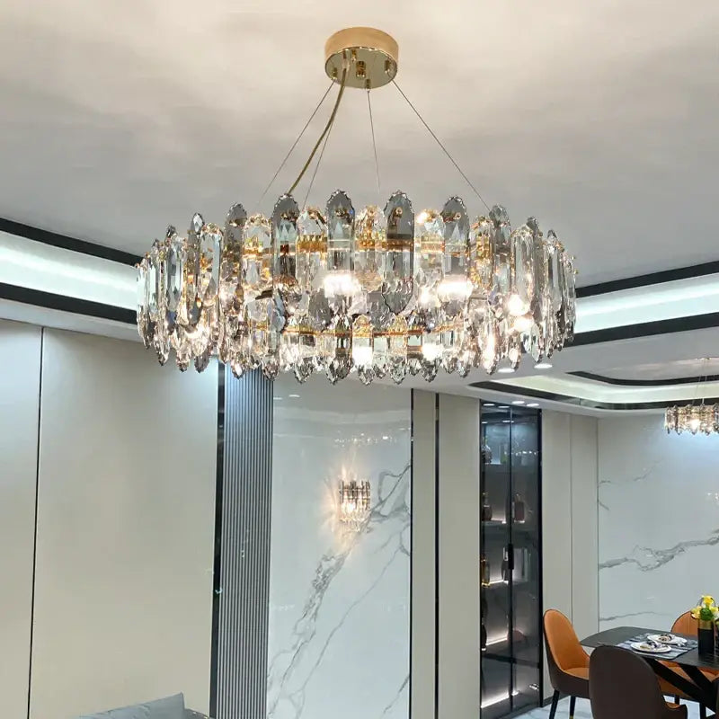 Luxurious decorbites crystal chandelier with gold tone mount and clear faceted crystals for living and dining rooms