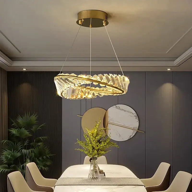 A decorbites crystal chandelier with a gold-toned metal frame and clear crystal facets for living room and bedroom