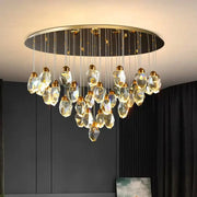 Modern decorbites crystal chandelier with faceted clear glass pendants and gold metal fixtures for living and dining rooms