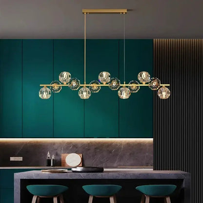 Gold-toned decorbites crystal chandelier with faceted crystal globe lights on a sleek bar for living and dining rooms