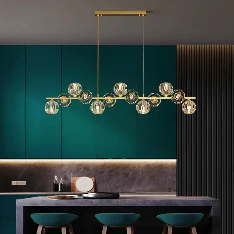 Gold-toned decorbites crystal chandelier with faceted crystal globe lights on a sleek bar for living and dining rooms