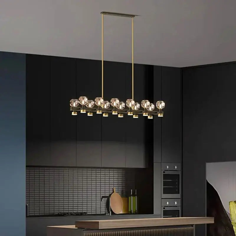 Gold-toned decorbites crystal chandelier with faceted crystal spheres on rods for living and dining room lighting