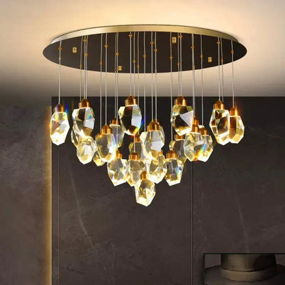 A modern decorbites crystal chandelier with faceted golden-toned glass pendants and a sleek gold frame pendant light