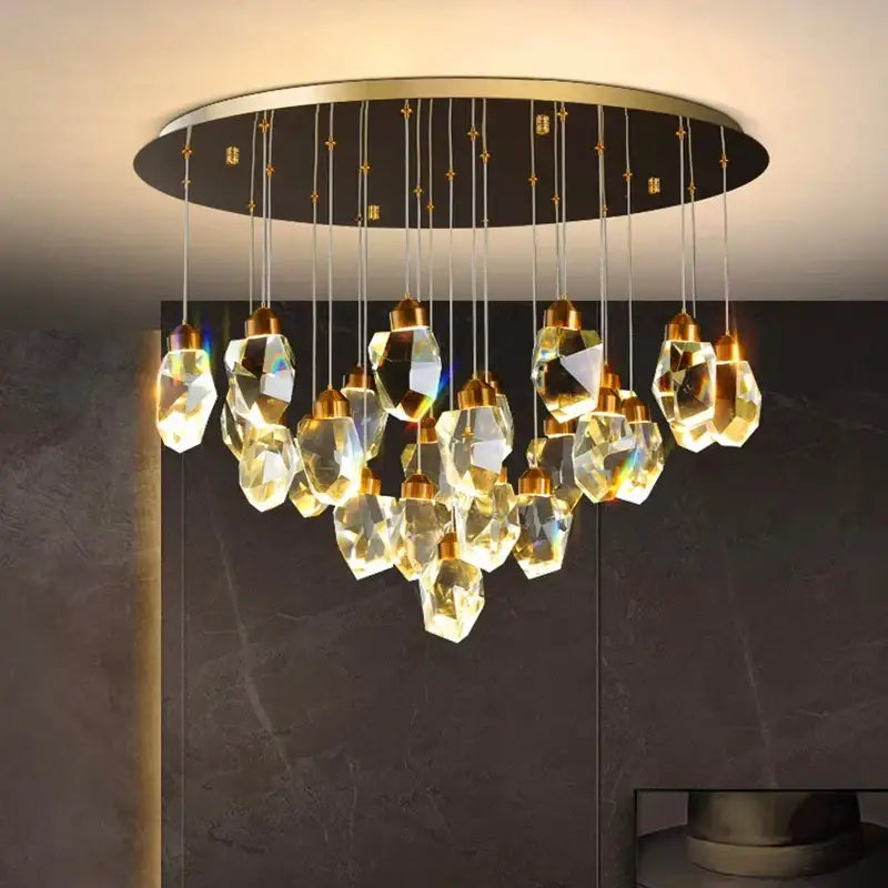A modern decorbites crystal chandelier with faceted golden-toned glass pendants and a sleek gold frame pendant light