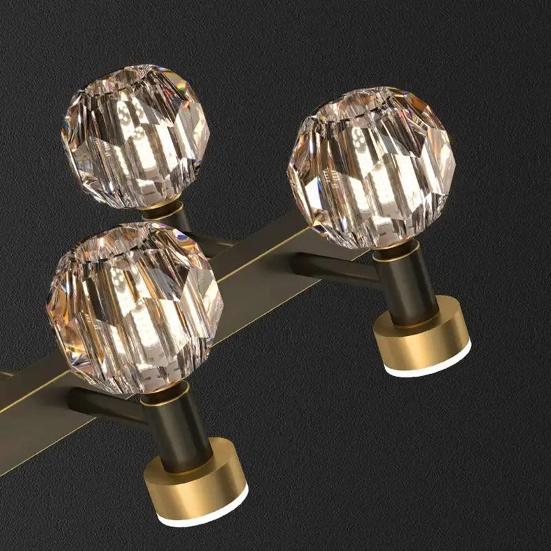 Decorbites crystal chandelier featuring crystal globe light fixtures with faceted glass and dark bronze gold metal arm