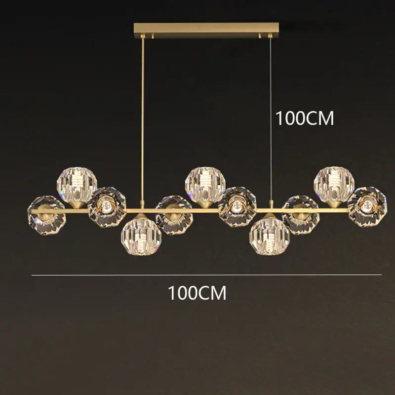 Gold-toned DecorBites crystal chandelier with faceted crystal spheres suspended from a horizontal bar for living room