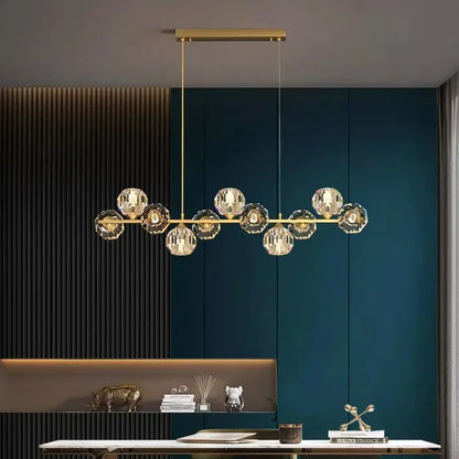Gold-toned decorbites crystal chandelier with faceted crystal globe shades on horizontal bar for living and dining room