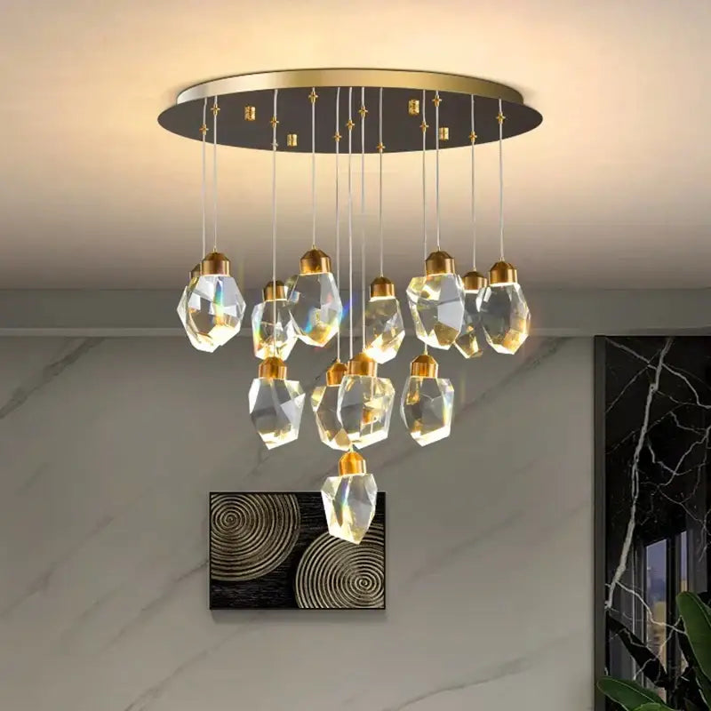 A decorbites crystal chandelier with gold-toned accents and faceted glass pendants for living and dining rooms
