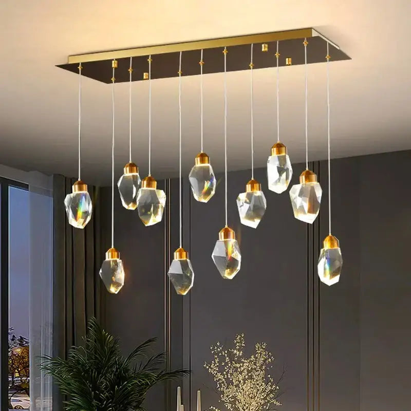 Modern rectangular decorbites crystal chandelier with gold-toned metal frame and hanging crystal pendant lights for living room