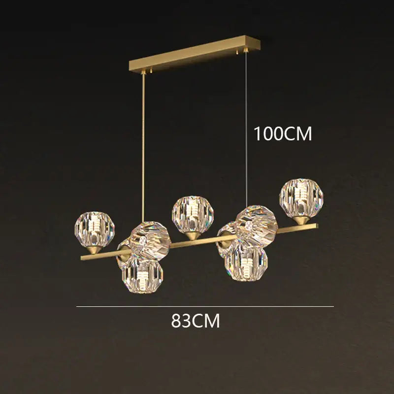 Gold-toned decorbites crystal chandelier with clear faceted crystal spheres for luxury living and dining room lighting