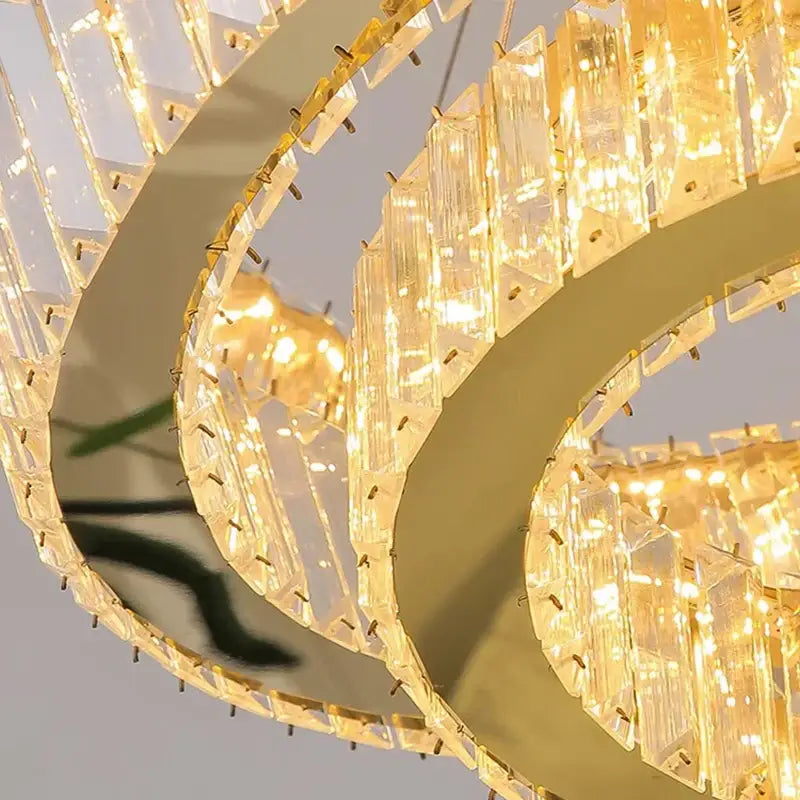 Golden spiral decorbites crystal chandelier with clear prisms and warm glowing lights for luxury living room lighting