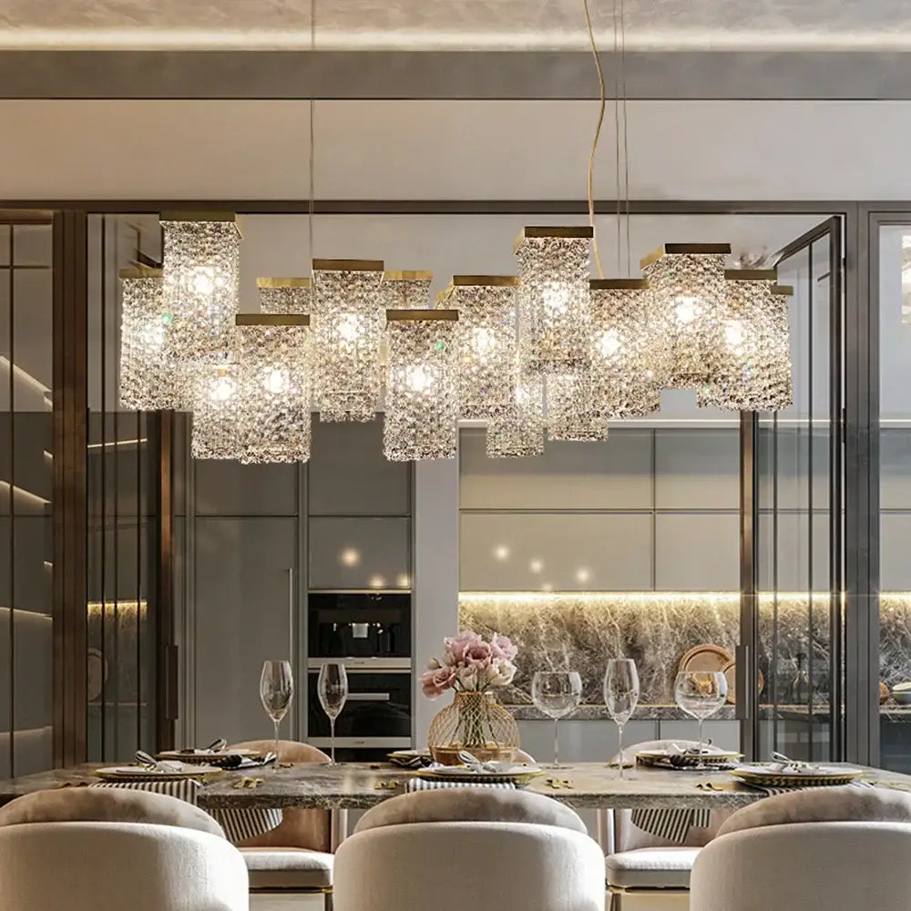 A decorbites crystal chandelier featuring multiple rectangular crystal-encrusted lights on a gold-toned frame