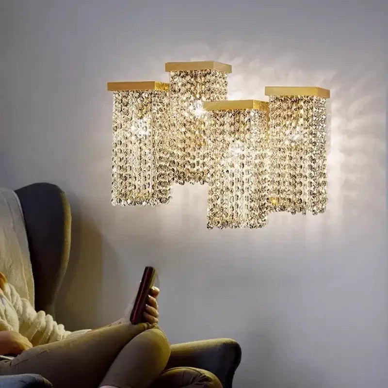 Gold-toned wall-mounted DecorBites crystal chandelier with cascading crystal beads for modern bar and restaurant lighting