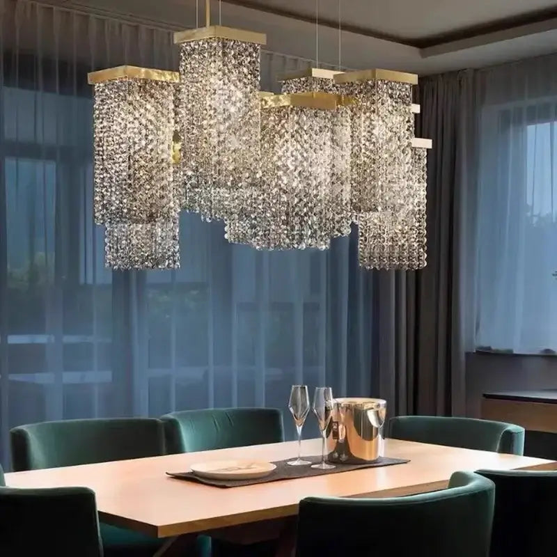A modern decorbites crystal chandelier with cascading clear crystal beads and gold rectangular frames for island lighting