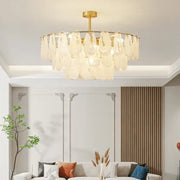 Gold-toned decorbites crystal chandelier with translucent leaf-shaped glass shades in circular pattern for living room and bedroom