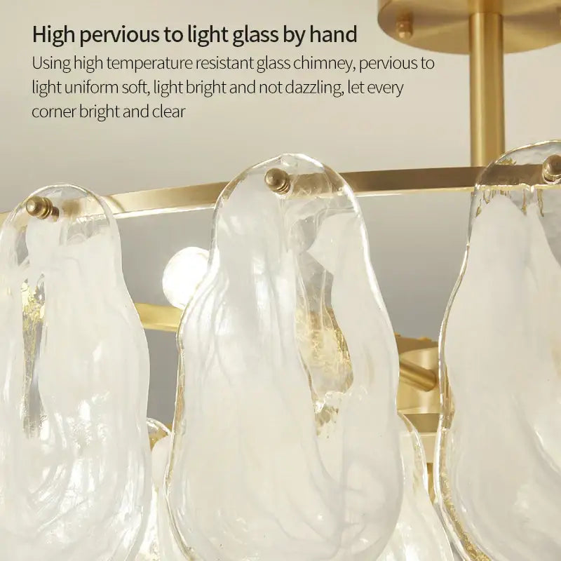 Decorbites crystal chandelier featuring transparent hand-blown glass penguin elements with gold-toned brass accents