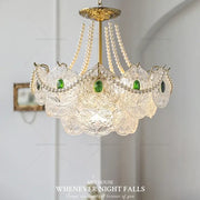 Elegant decorbites crystal chandelier with gold metal accents, clear glass panels, green gemstones, and white pearls for home decor