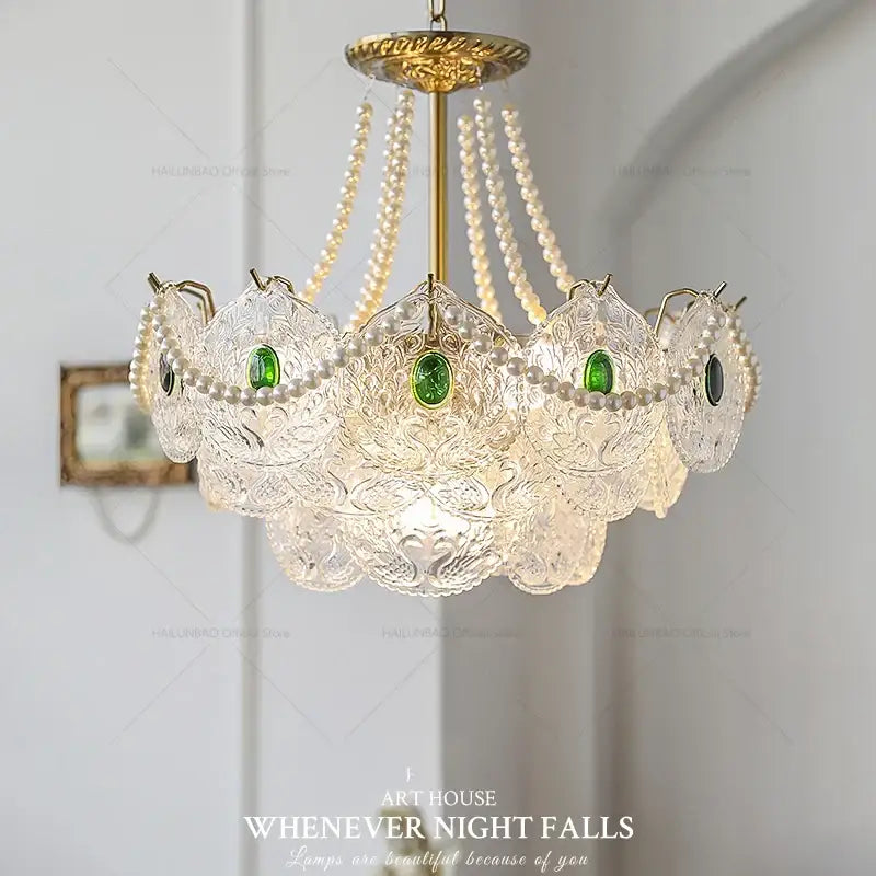 Elegant decorbites crystal chandelier with gold metal accents, clear glass panels, green gemstones, and white pearls for home decor