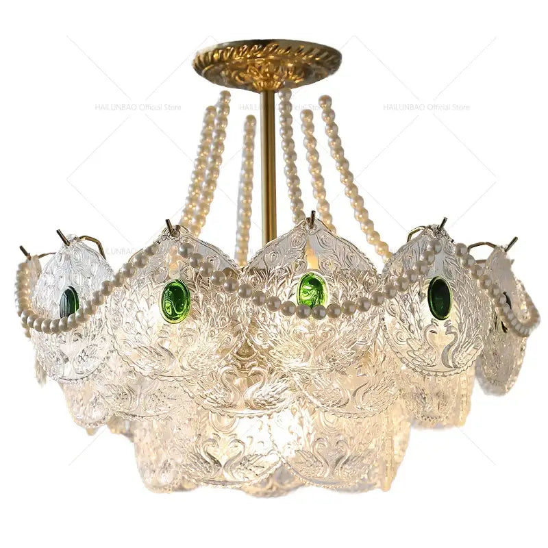 Elegant decorbites crystal chandelier with clear etched glass, green gemstones, and cream pearl strands for chic decor