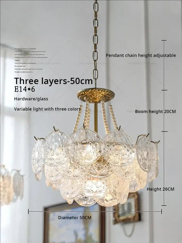 Elegant decorbites crystal chandelier with three-tiered brass frame and clear intricately etched glass shades for home decor