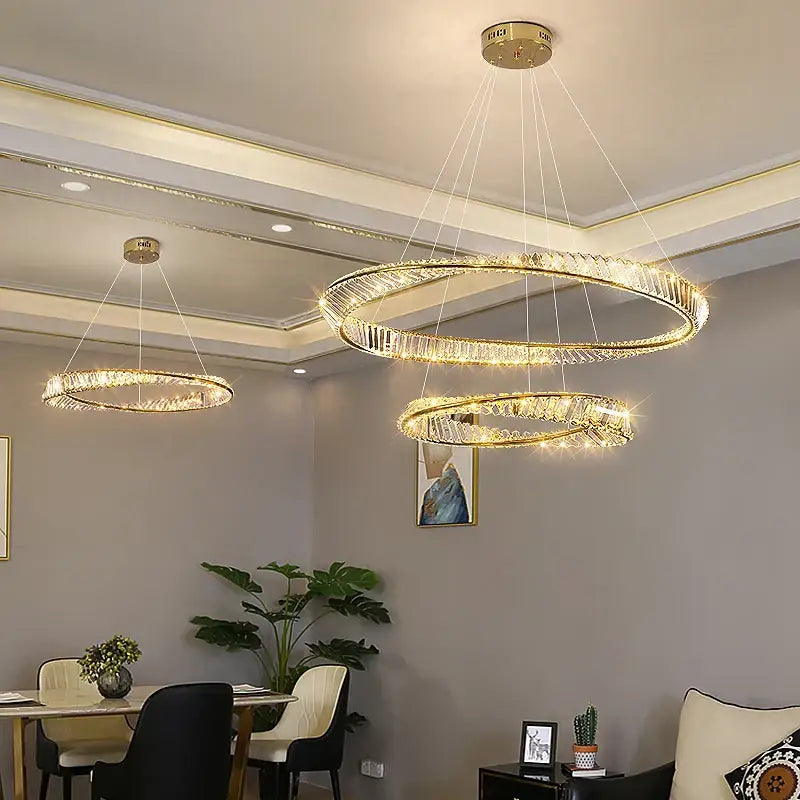 Gold-toned decorbites crystal chandelier with double rings, crystal accents, and embedded LED lights for modern living spaces