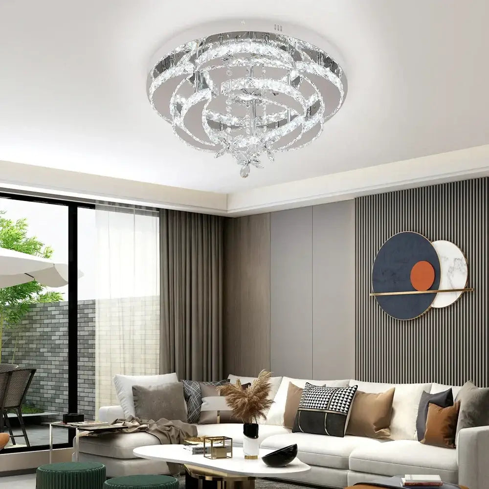 A modern decorbites crystal chandelier with circular clear crystal rings and chrome accents for living and dining rooms