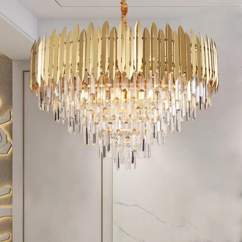 A luxurious gold-toned decorbites crystal chandelier with cascading prisms for modern dining room or bedroom lighting