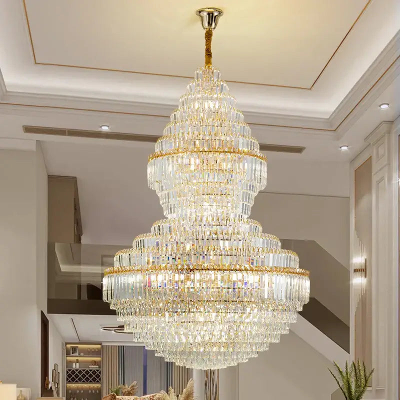 A decorbites crystal chandelier with gold-toned metal and cascading clear faceted crystals for modern loft lighting