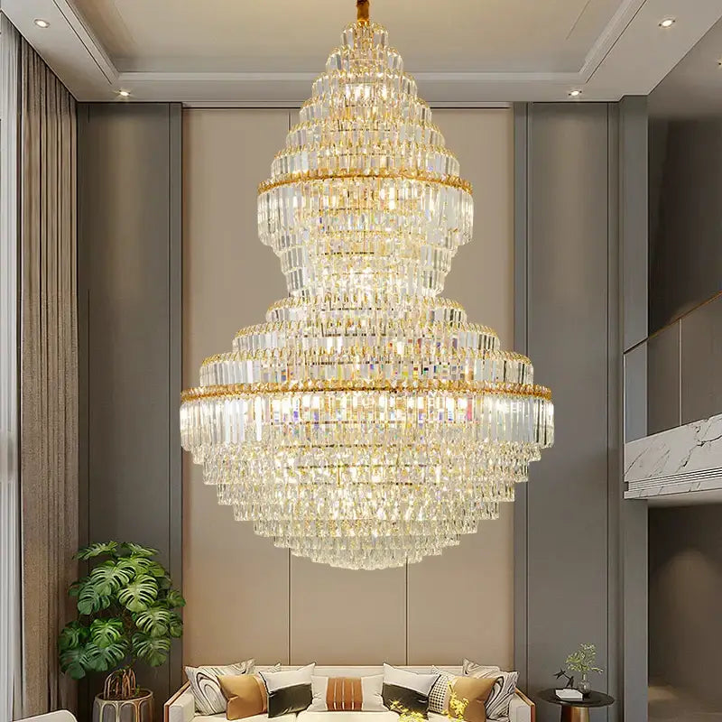 A multi-tiered decorbites crystal chandelier with gold-toned metal accents and cascading clear crystals for loft lighting