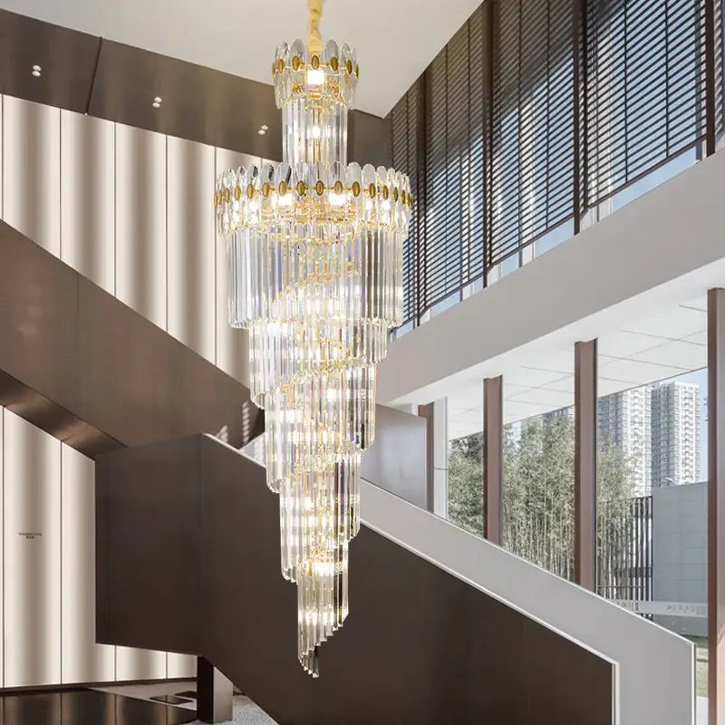 A decorbites crystal chandelier with gold accents and cascading prisms in a modern duplex villa hall lighting