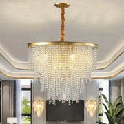 A luxuriously gold-toned decorbites crystal chandelier with cascading clear crystal droplets for modern elegance