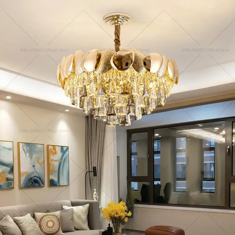 Gold-toned decorbites crystal chandelier with tiered design featuring metallic orbs and cascading crystal droplets for elegant spaces