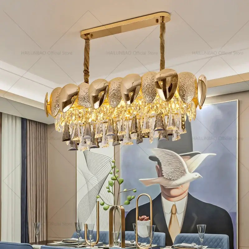 Gold-toned decorbites crystal chandelier with modern polished metallic shells and cascading crystal droplets for living spaces