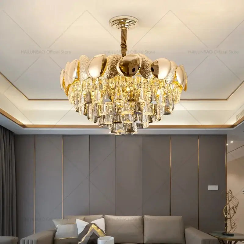 Gold-toned decorbites crystal chandelier with polished metallic spheres and cascading crystal droplets for modern elegance