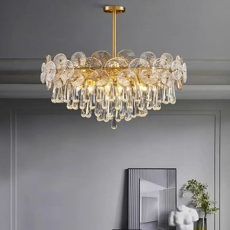 Elegant gold-toned decorbites crystal chandelier with clear crystal flower discs and teardrop crystals for living spaces
