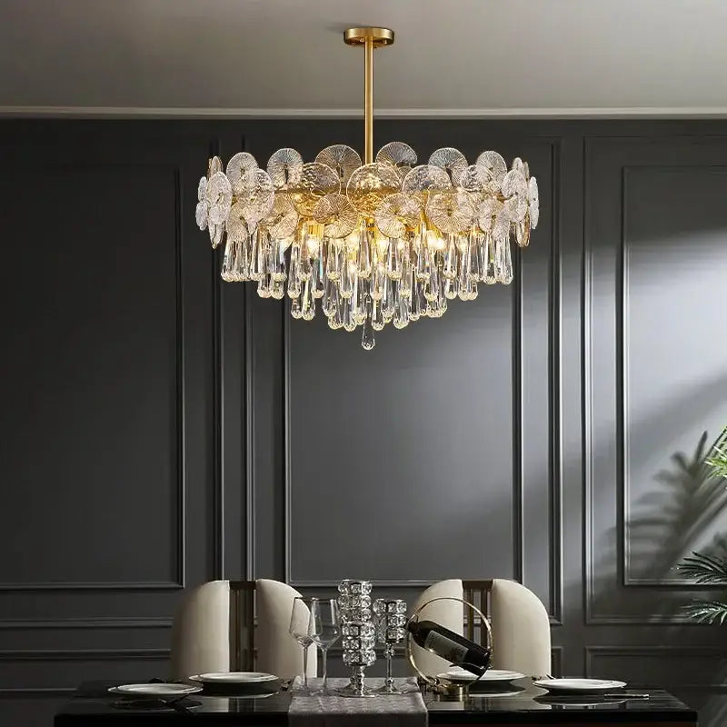 A luxurious gold-toned decorbites crystal chandelier with intricate crystal petals and teardrop crystals for living rooms