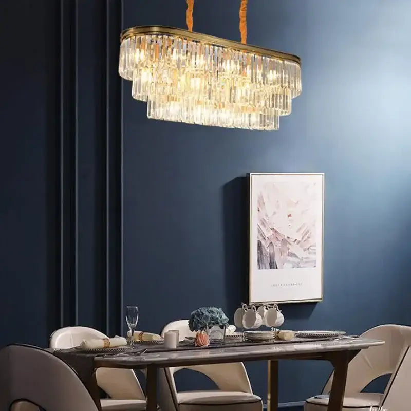 Gold-toned oval decorbites crystal chandelier with cascading clear crystal prisms for modern indoor lighting
