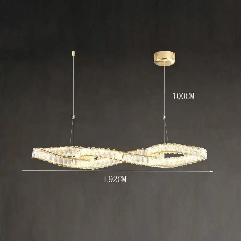 Gold-toned infinity-shaped decorbites crystal chandelier with crystal accents and led lighting for dining and living rooms