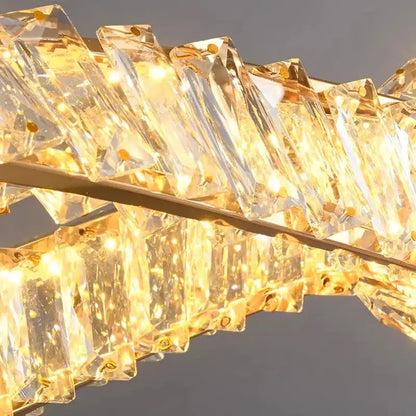 Modern golden-tinted faceted crystal prisms in a curved line form the decorbites crystal chandelier pendant light fixture