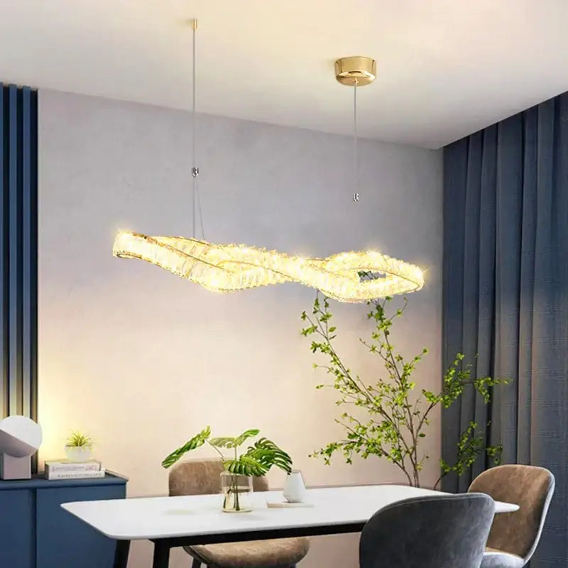 Golden modern decorbites crystal chandelier pendant light with sleek twisted design and embedded crystal accents for dining room