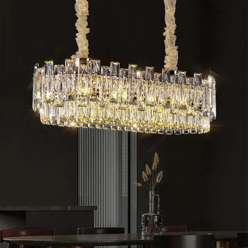 A modern oval decorbites crystal chandelier with clear faceted prisms and white cords for luxury living spaces