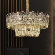 A decorbites crystal chandelier with multi-tiered cascading rectangular prisms illuminated by warm golden lights