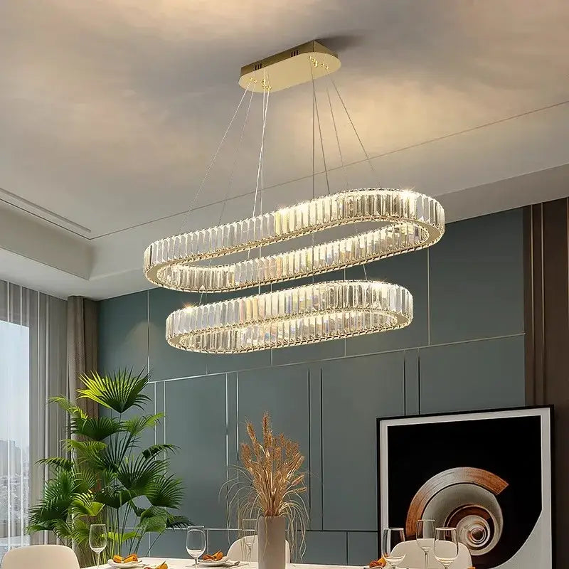 Modern decorbites crystal chandelier with double-loop clear crystal prisms and gold-toned mount for living and dining rooms