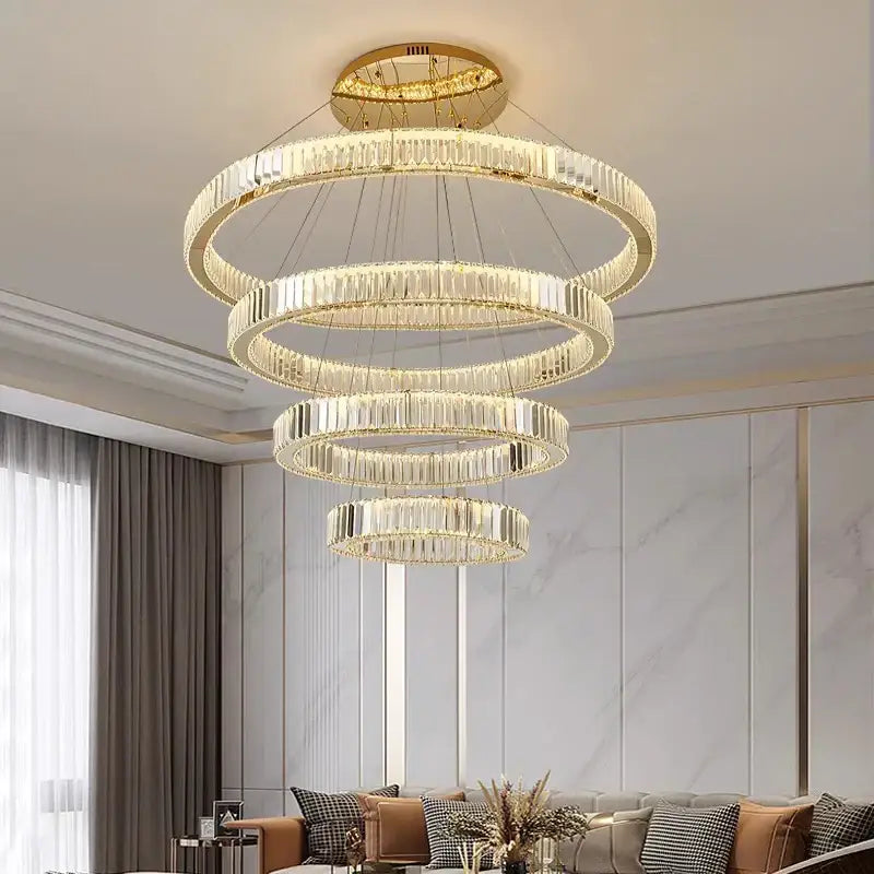 A modern decorbites crystal chandelier with cascading crystal rings and gold-toned ceiling mount for dining rooms