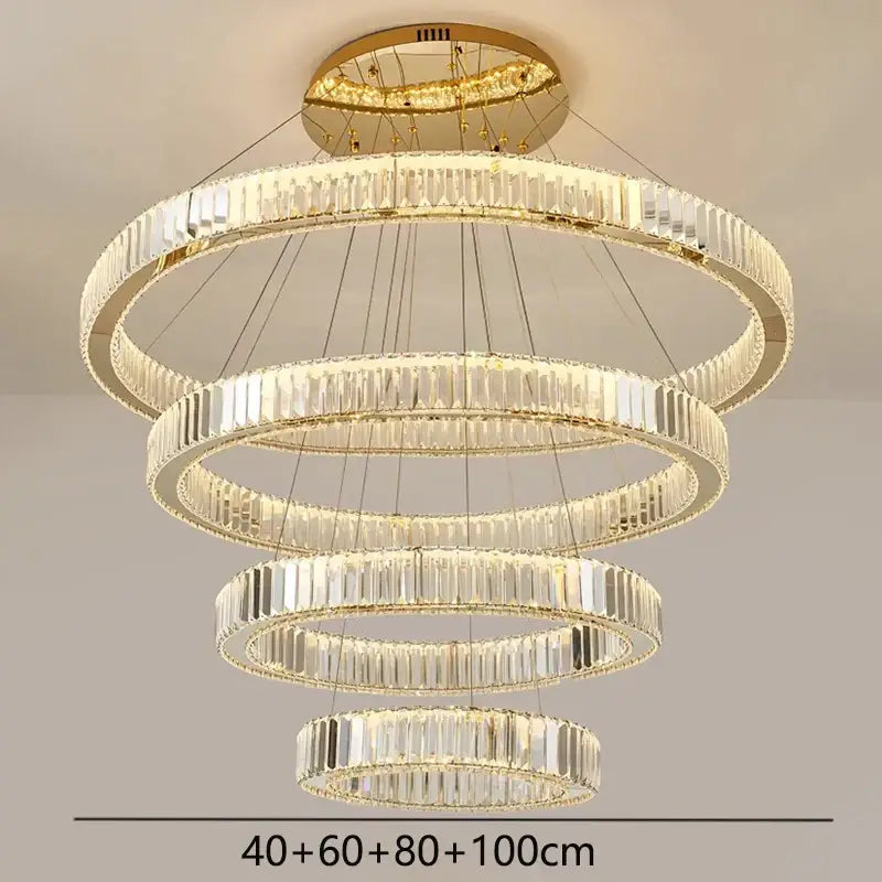 Decorbites crystal chandelier with five concentric rings of clear crystal prisms in a gold-toned metal frame for modern lighting