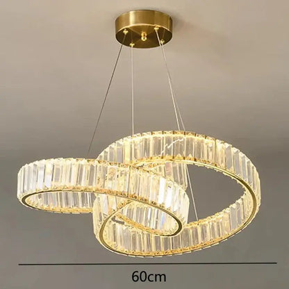 Gold-toned decorbites crystal chandelier with double rings, clear crystal facets, and integrated led lighting for modern interiors